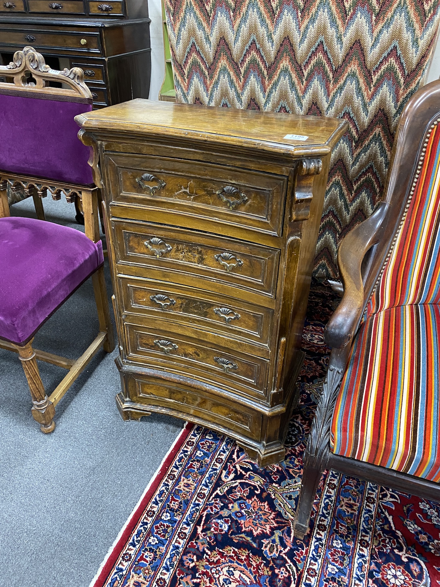 A small 18th century Italian walnut concave front chest of drawers, width 55cm, depth 28cm, height 89cm